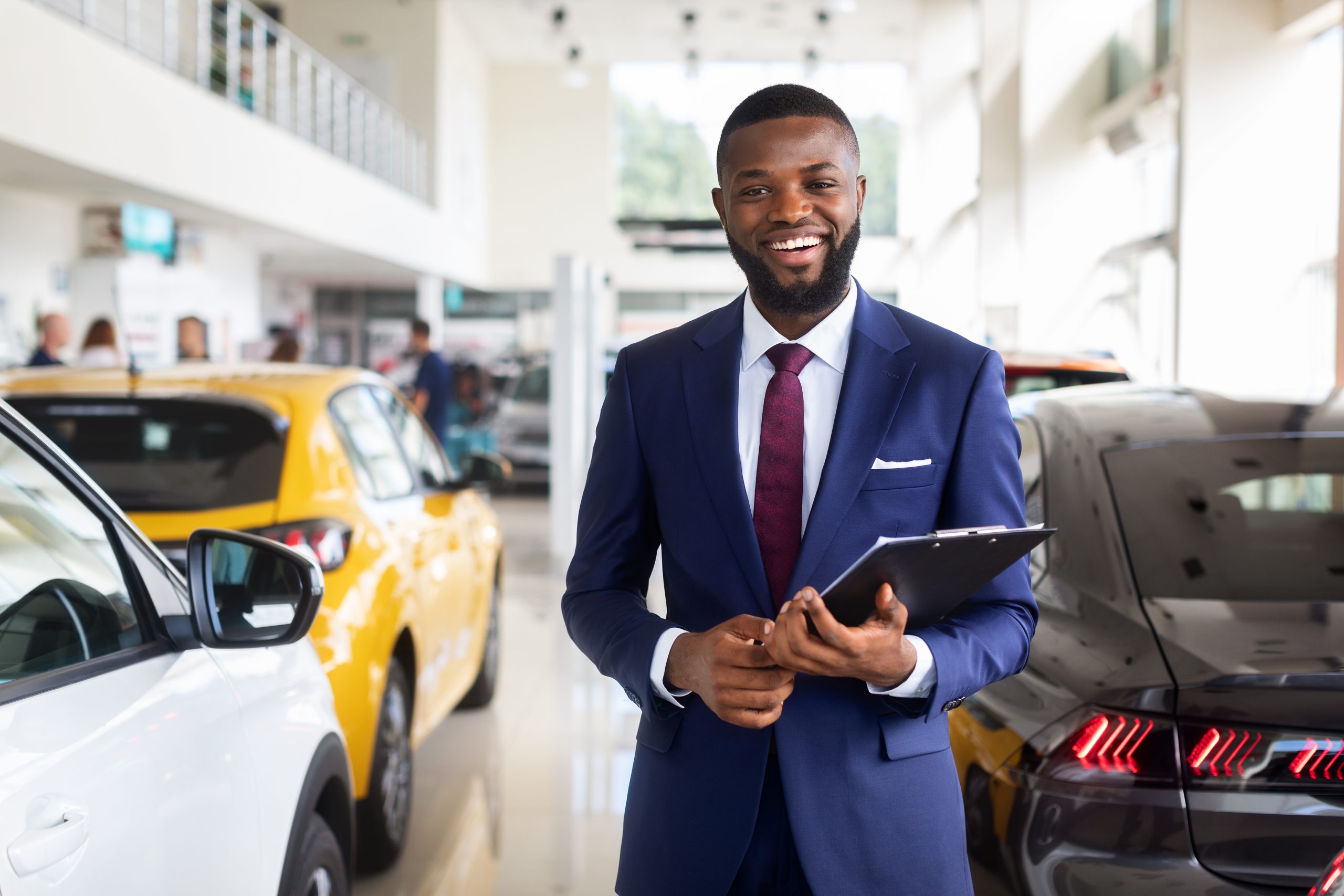 car dealer smiling young black salesman in suit a 2025 03 18 19 09 49 utc scaled