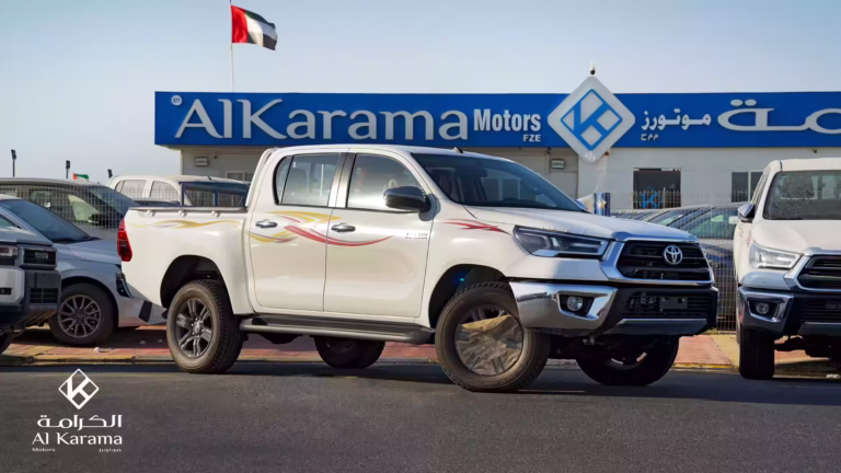 2026 Toyota Hilux SR5 Double Cab 4WD White parked at Al Karama Motors Dubai showroom