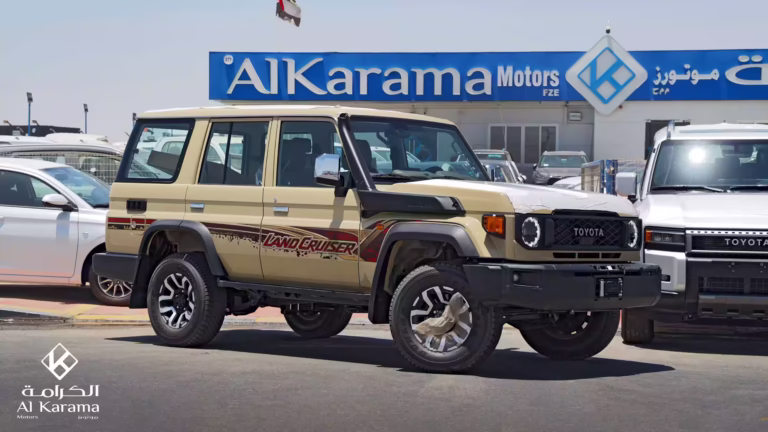 Beige 2026 Toyota Land Cruiser LC76 2.8L Diesel Hardtop parked in front of Al Karama Motors dealership