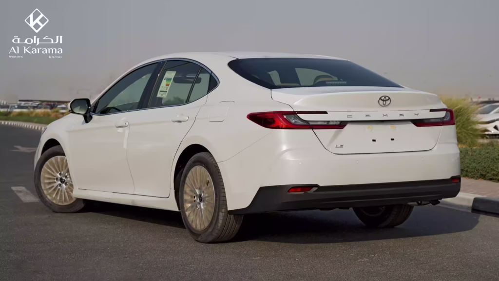 Rear three-quarter view of white 2026 Toyota Camry LE Petrol