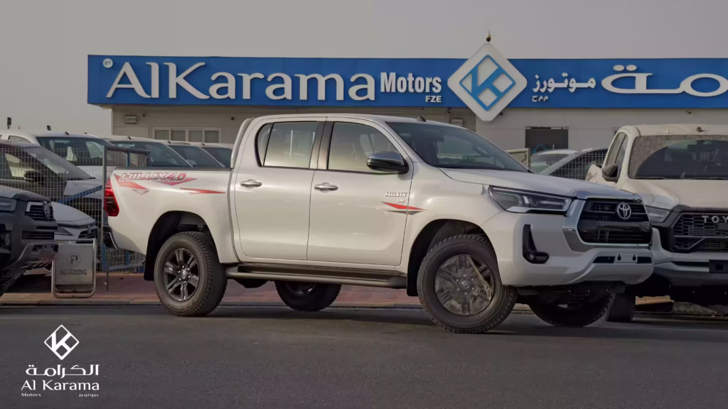 White 2026 Toyota Hilux 4.0L V6 Double Cabin side view at Al Karama Motors Dubai